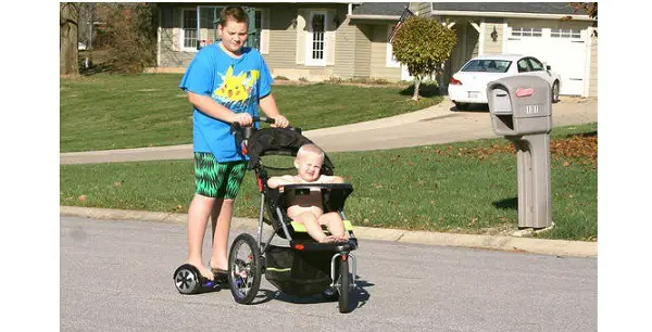 dad on hoverboard with baby in stroller