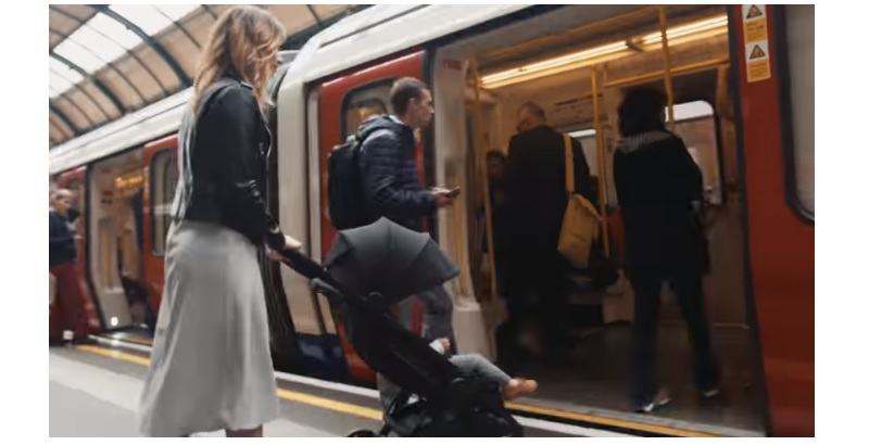 mom with stroller getting in a train